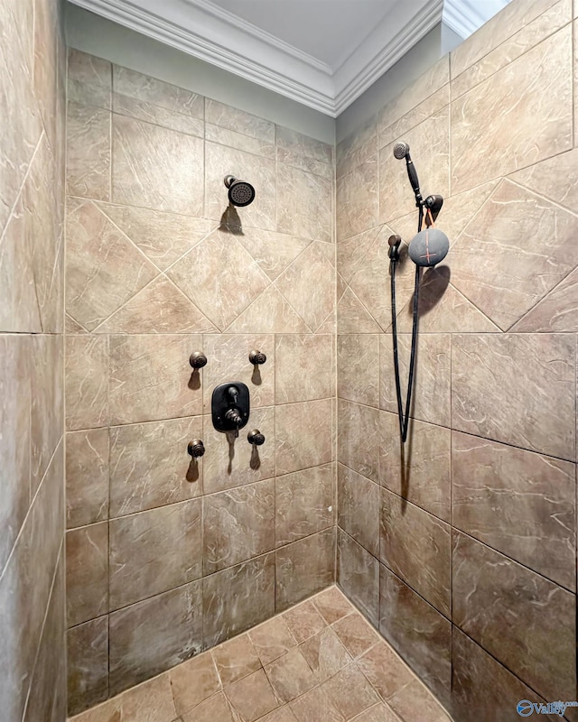 bathroom with crown molding and a tile shower