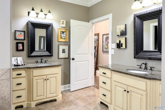 bathroom with ornamental molding, vanity, and tile patterned flooring