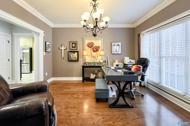 office area featuring wood-type flooring, a healthy amount of sunlight, crown molding, and a notable chandelier