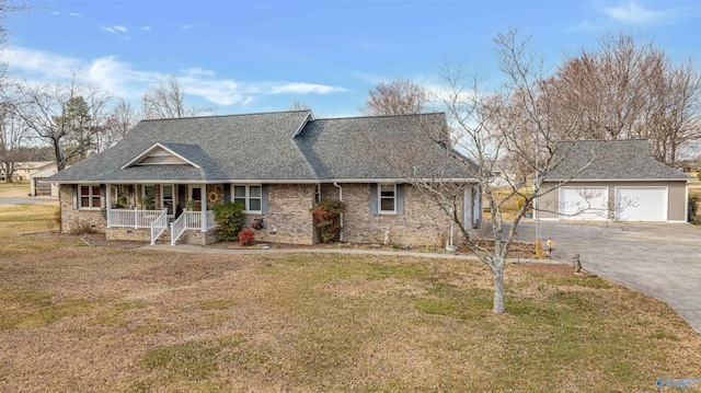 view of front facade featuring a garage, a porch, roof with shingles, and a front yard