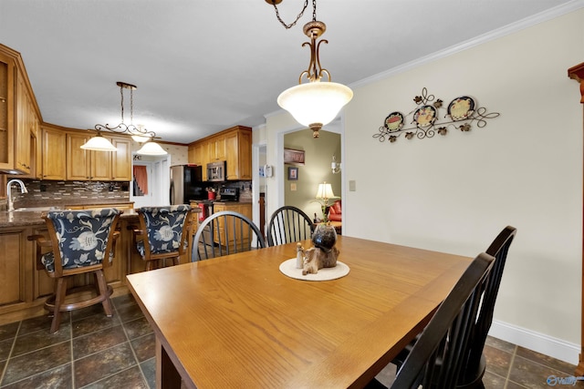 dining area featuring crown molding and baseboards