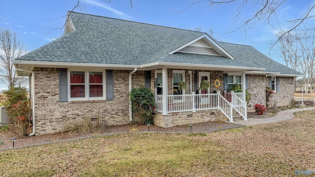 view of front of home with crawl space, covered porch, brick siding, and roof with shingles