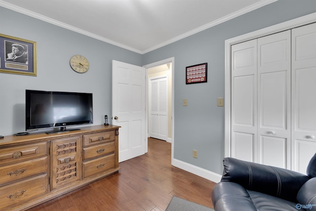 living area featuring dark wood-style floors, crown molding, and baseboards