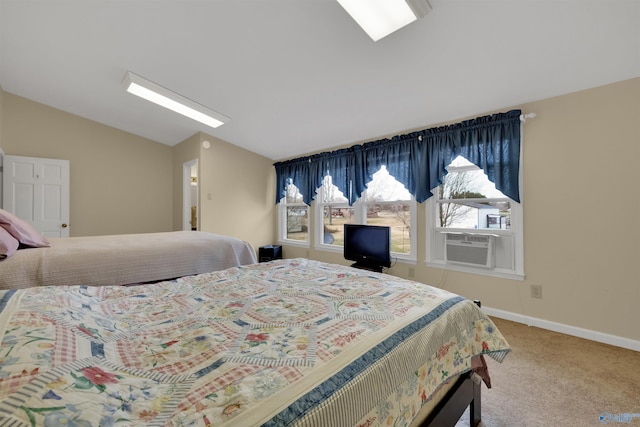 carpeted bedroom with lofted ceiling and baseboards