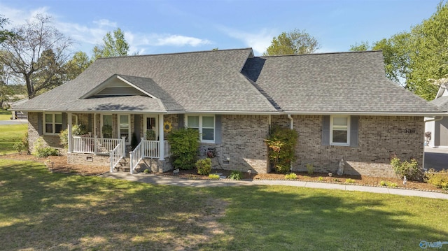 view of front of property featuring a porch, a shingled roof, a front lawn, and brick siding