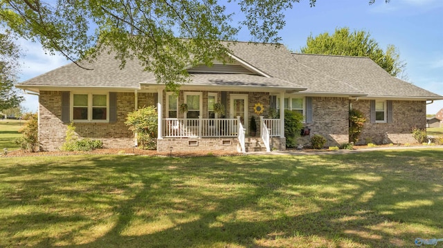 view of front of house with covered porch, a front yard, and brick siding