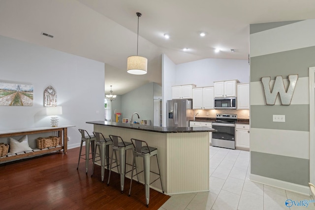 6807 Breyerton Way SE, Owens Cross Roads, AL 35763 - kitchen with stainless steel appliances, a kitchen breakfast bar, a sink, tasteful backsplash, and a kitchen island with sink