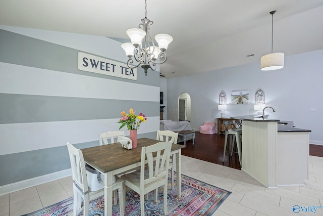 6807 Breyerton Way SE, Owens Cross Roads, AL 35763 - dining room with arched walkways, light tile patterned floors, and a chandelier