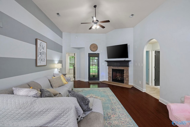 6807 Breyerton Way SE, Owens Cross Roads, AL 35763 - living area featuring a ceiling fan, wood finished floors, arched walkways, a stone fireplace, and baseboards