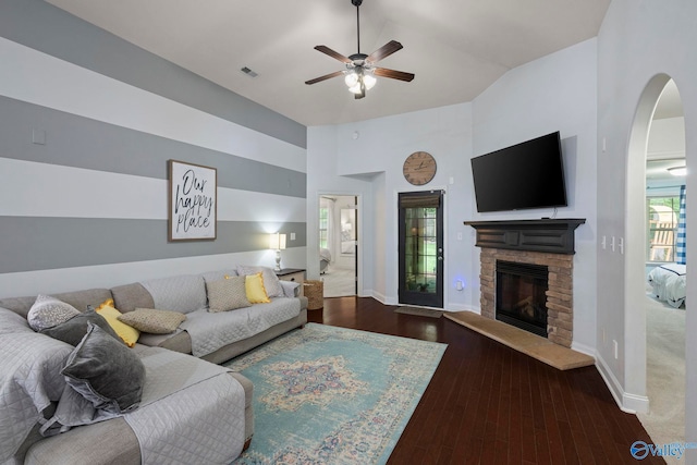 6807 Breyerton Way SE, Owens Cross Roads, AL 35763 - living room with baseboards, arched walkways, a ceiling fan, a stone fireplace, and wood finished floors