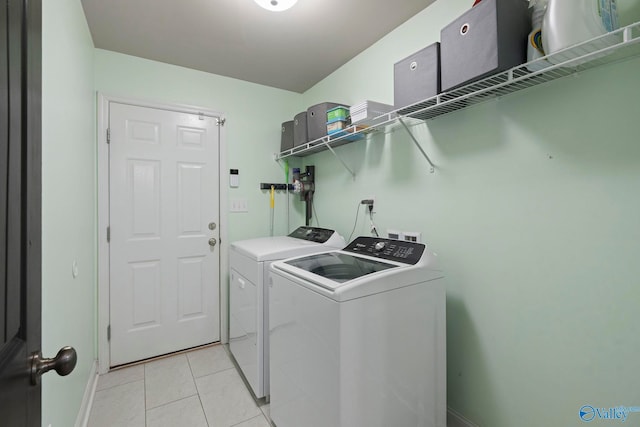 6807 Breyerton Way SE, Owens Cross Roads, AL 35763 - laundry room with washing machine and dryer, light tile patterned flooring, and baseboards