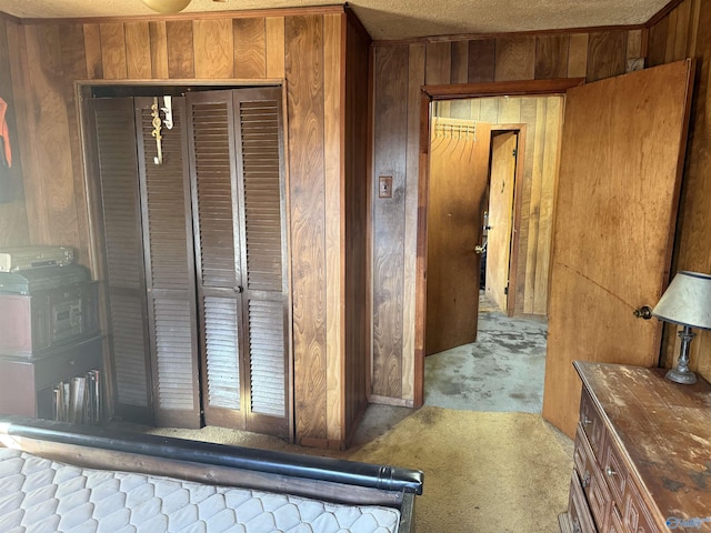 interior space featuring wooden walls, a textured ceiling, and carpet flooring