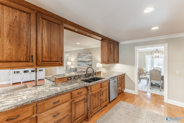 406 Zandale Dr SW, Huntsville, AL 35801 - kitchen with a sink, stainless steel dishwasher, brown cabinetry, ornamental molding, and stone countertops