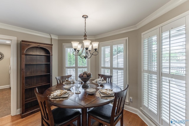406 Zandale Dr SW, Huntsville, AL 35801 - dining room featuring a chandelier, light wood-style floors, baseboards, and ornamental molding