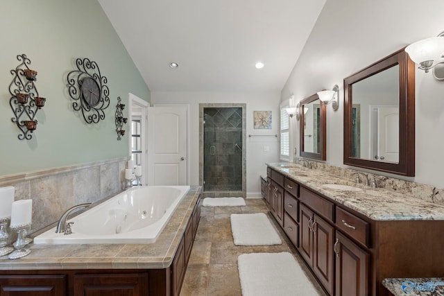 406 Zandale Dr SW, Huntsville, AL 35801 - bathroom with lofted ceiling, a stall shower, a whirlpool tub, and double vanity