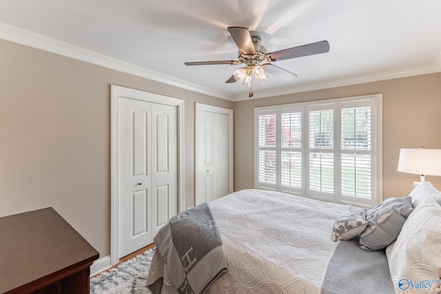 406 Zandale Dr SW, Huntsville, AL 35801 - bedroom with two closets, ornamental molding, ceiling fan, and wood finished floors