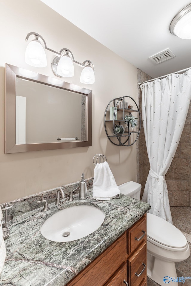 406 Zandale Dr SW, Huntsville, AL 35801 - full bathroom with vanity, toilet, and tiled shower