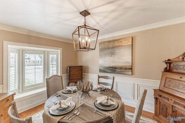 406 Zandale Dr SW, Huntsville, AL 35801 - dining space with a chandelier, ornamental molding, light wood-type flooring, a wainscoted wall, and a decorative wall