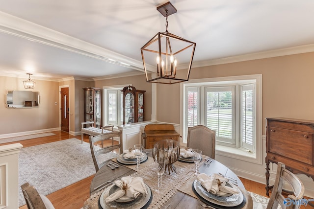 406 Zandale Dr SW, Huntsville, AL 35801 - dining room with a chandelier, crown molding, wood finished floors, and baseboards