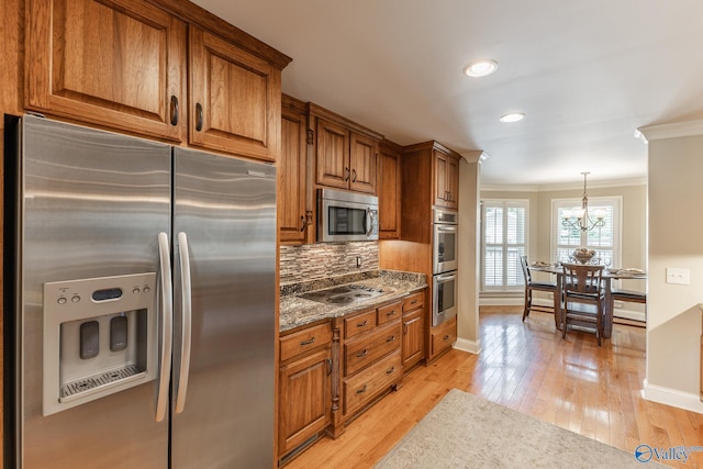 406 Zandale Dr SW, Huntsville, AL 35801 - kitchen featuring stainless steel appliances, crown molding, brown cabinetry, baseboards, and recessed lighting