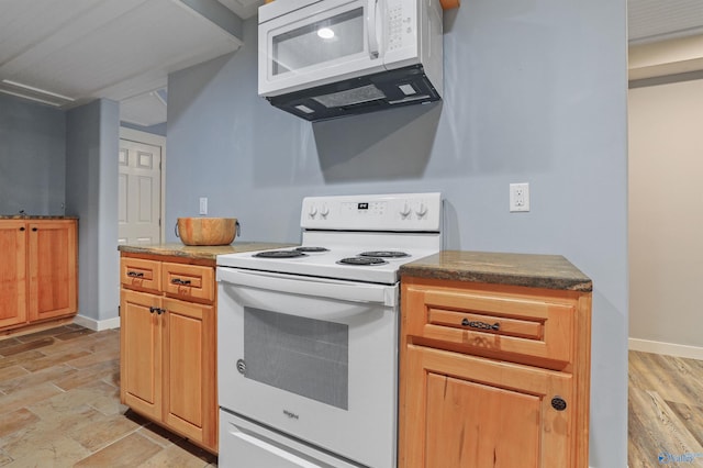 kitchen with light hardwood / wood-style flooring and white appliances