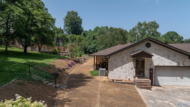 view of front of property featuring a garage, cooling unit, and a front lawn