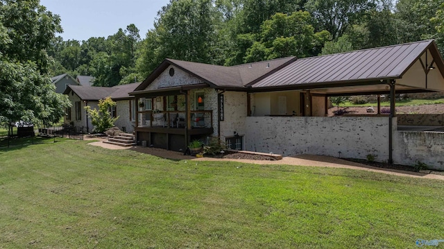 rear view of house featuring a lawn