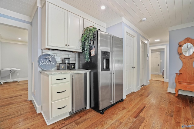 kitchen featuring stainless steel fridge, light hardwood / wood-style floors, wine cooler, white cabinets, and backsplash