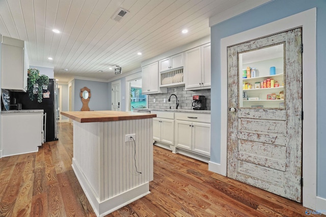 kitchen featuring wooden ceiling, white cabinetry, and hardwood / wood-style floors