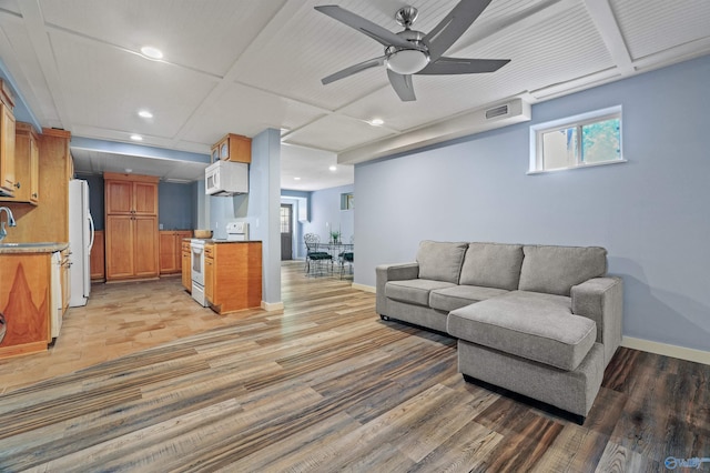 living room featuring light hardwood / wood-style floors, sink, and ceiling fan