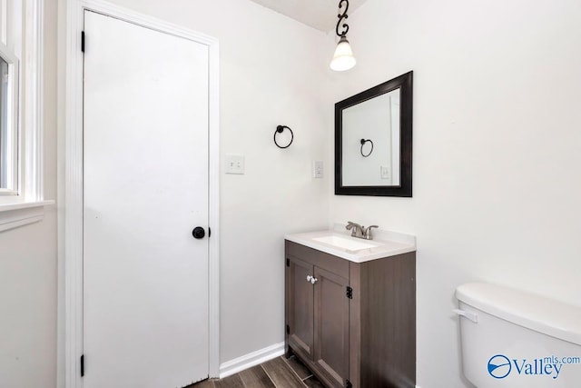 bathroom featuring wood finished floors, vanity, and toilet