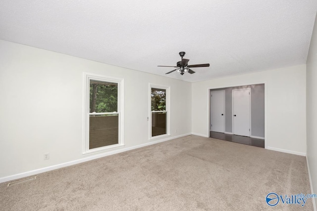 interior space featuring visible vents, a ceiling fan, carpet floors, a closet, and baseboards