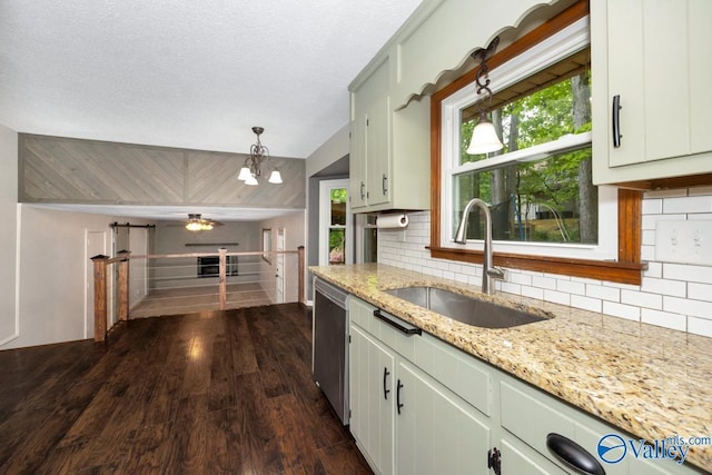 kitchen with ceiling fan with notable chandelier, decorative backsplash, dark wood-style flooring, and a sink