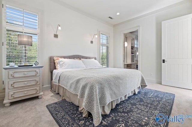 bedroom featuring light colored carpet, visible vents, and baseboards