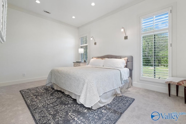 carpeted bedroom with baseboards, multiple windows, recessed lighting, and visible vents