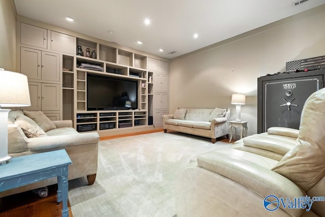 living area featuring light carpet, visible vents, and recessed lighting