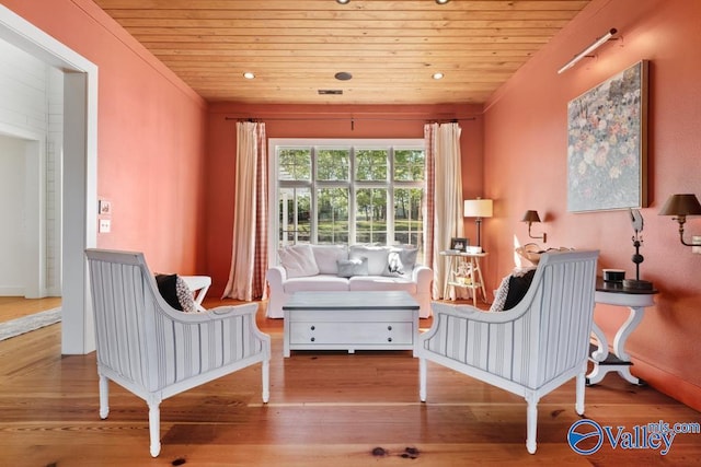living area with wooden ceiling and wood finished floors