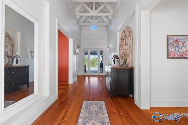 hallway featuring wood finished floors and baseboards