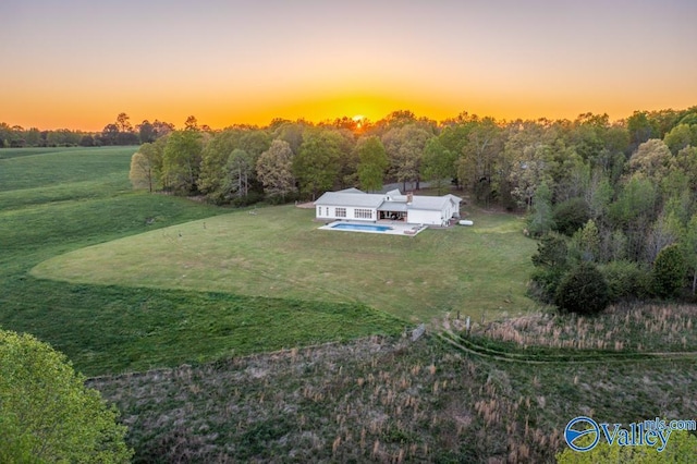 aerial view at dusk featuring a rural view
