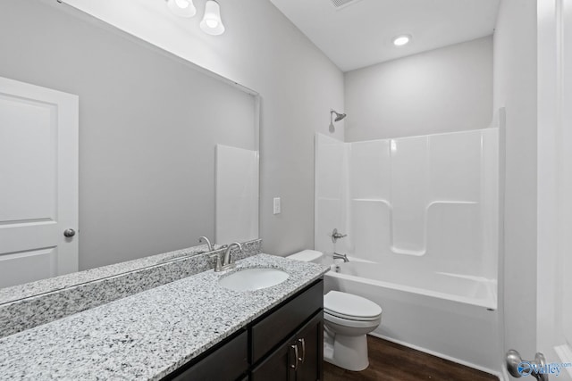 full bathroom featuring vanity, shower / washtub combination, toilet, and hardwood / wood-style floors