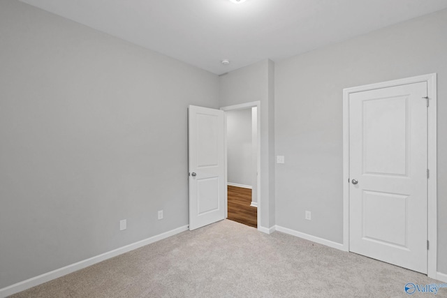 unfurnished bedroom featuring light colored carpet