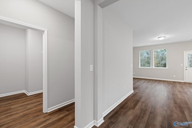 corridor with dark hardwood / wood-style flooring