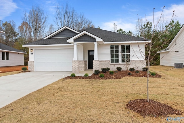 view of front facade with a garage, central AC, and a front lawn