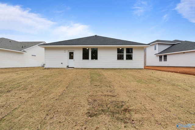 rear view of property featuring a yard