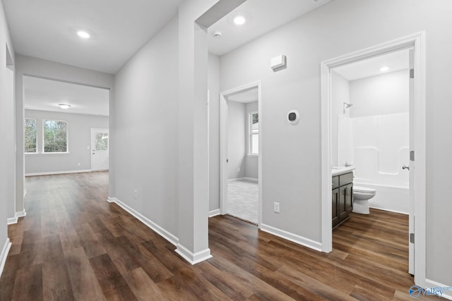 corridor featuring dark wood-type flooring