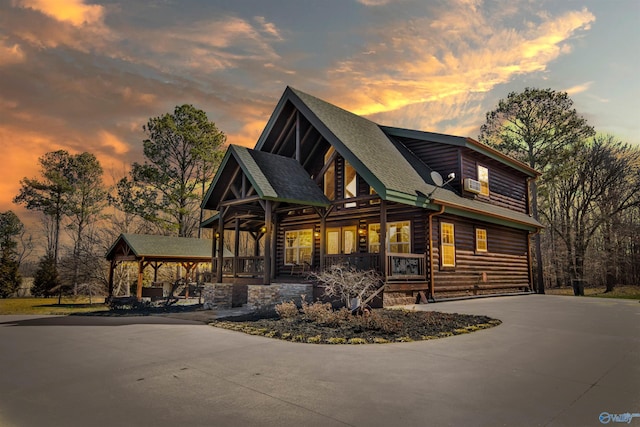 view of front of house featuring roof with shingles, driveway, and a gazebo