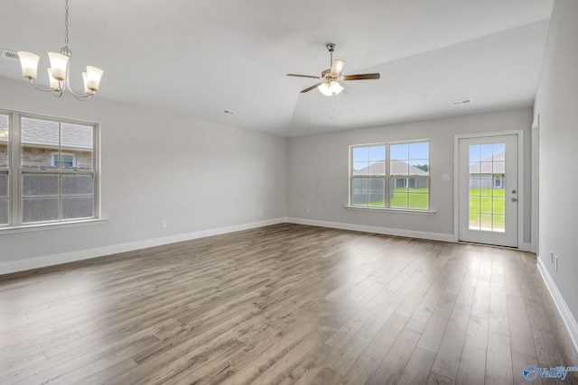 unfurnished living room with hardwood / wood-style floors, lofted ceiling, and ceiling fan with notable chandelier