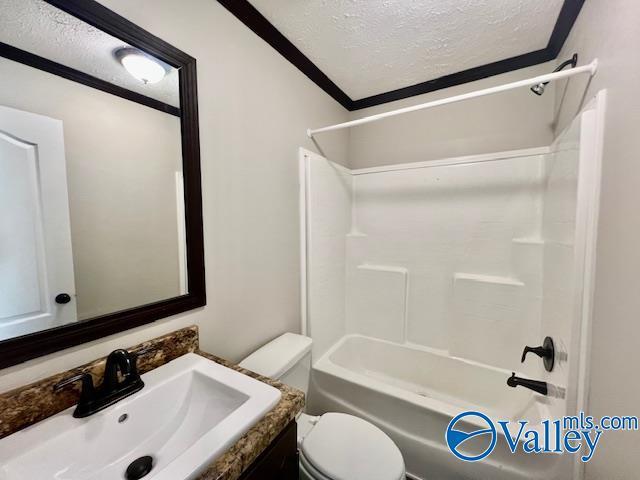 full bathroom featuring vanity, shower / tub combination, crown molding, toilet, and a textured ceiling