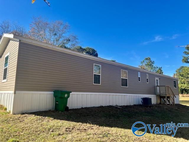 view of side of home featuring a yard