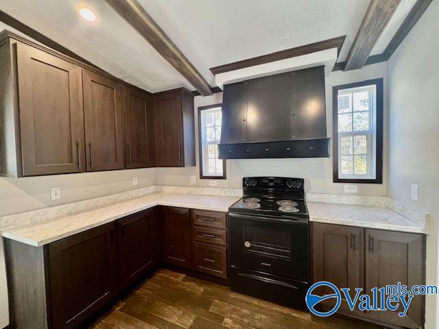 kitchen with beam ceiling, ventilation hood, black electric range oven, and plenty of natural light